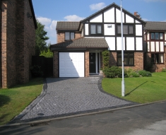 SPECKLED GREY GRANITE SETTS COMPLIMENT SIMONS BMW IN WESTHOUGHTON