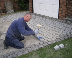 SPECKLED GREY GRANITE SETTS COMPLIMENT SIMONS BMW IN WESTHOUGHTON