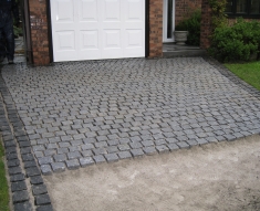 SPECKLED GREY GRANITE SETTS COMPLIMENT SIMONS BMW IN WESTHOUGHTON